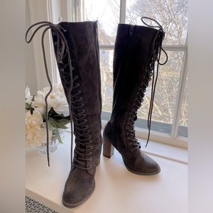 Knee high lace up brown suede heeled boots.